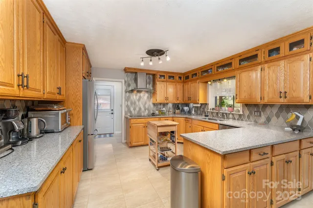 a kitchen that has a sink and a stove in it