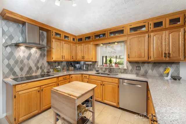 a kitchen with stainless steel appliances granite countertop a sink and cabinets