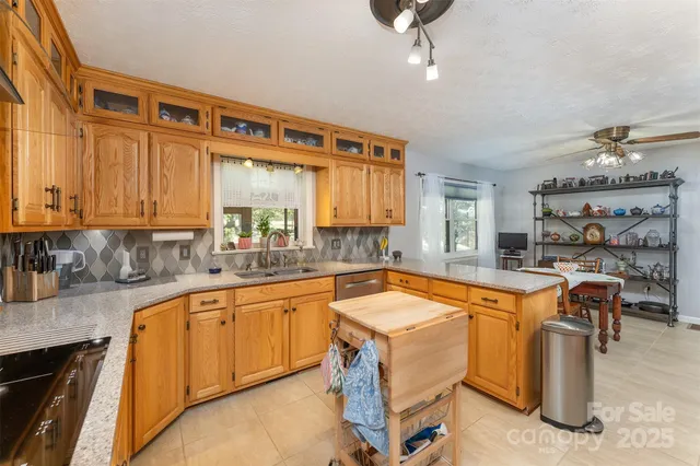 a kitchen with a sink and chairs