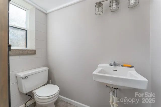 a bathroom with a sink mirror and toilet