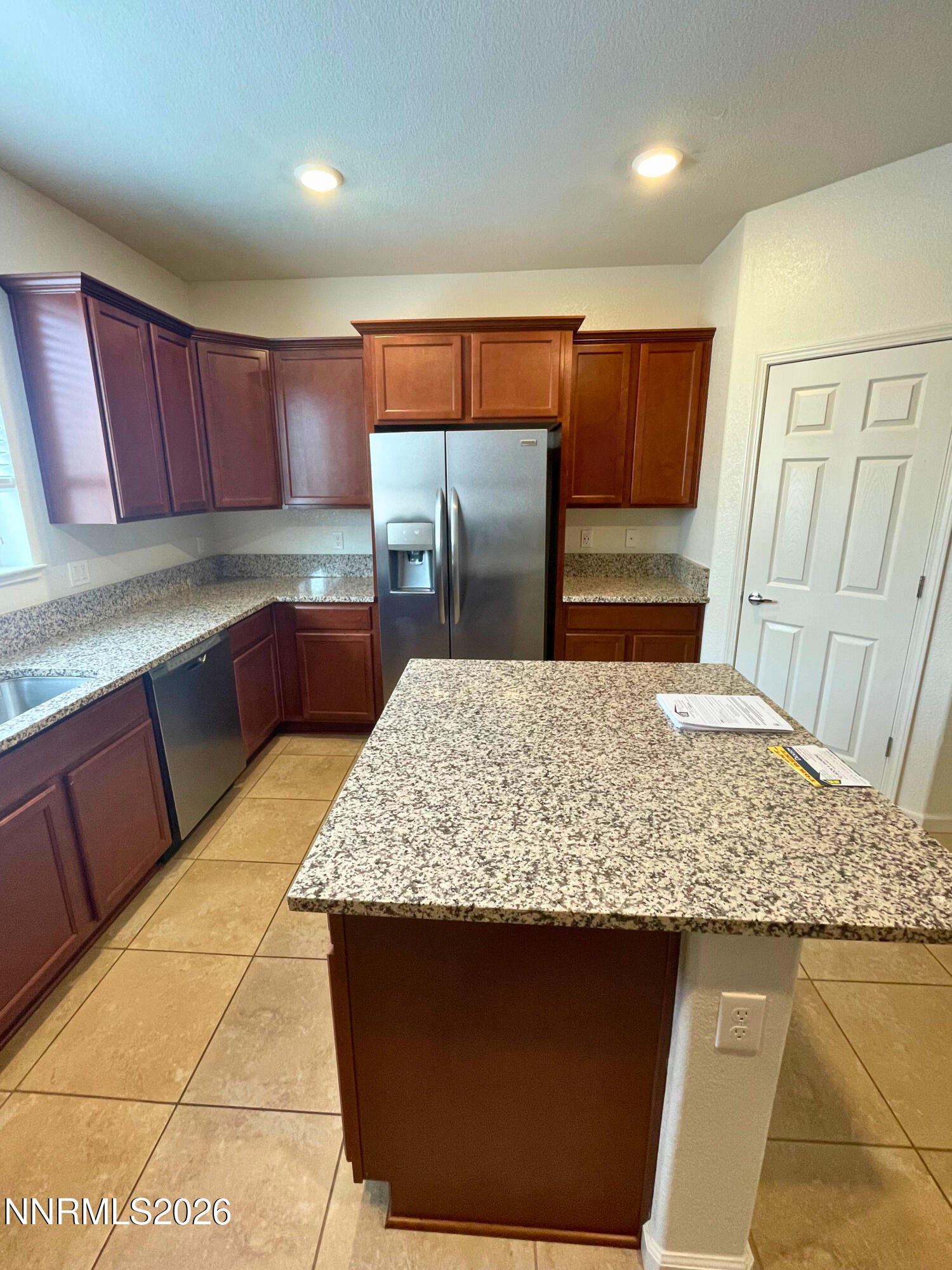 3050 Sterling Ridge Circle Sparks, NV 89431 - Photo 5 of 10 a kitchen with stainless steel appliances kitchen island granite countertop a sink stove and cabinets