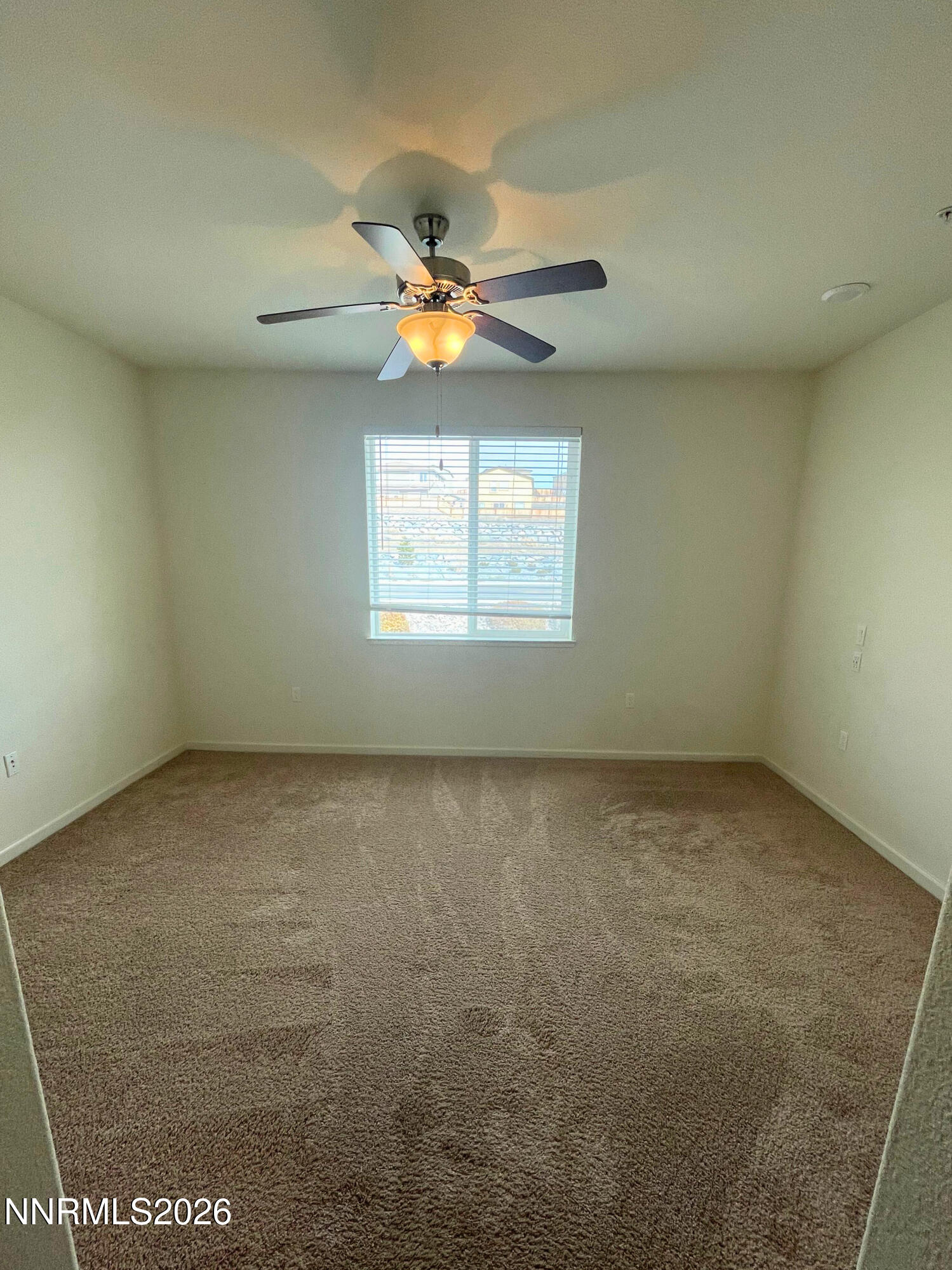 3050 Sterling Ridge Circle Sparks, NV 89431 - Photo 6 of 10 an empty room with windows and ceiling fan view