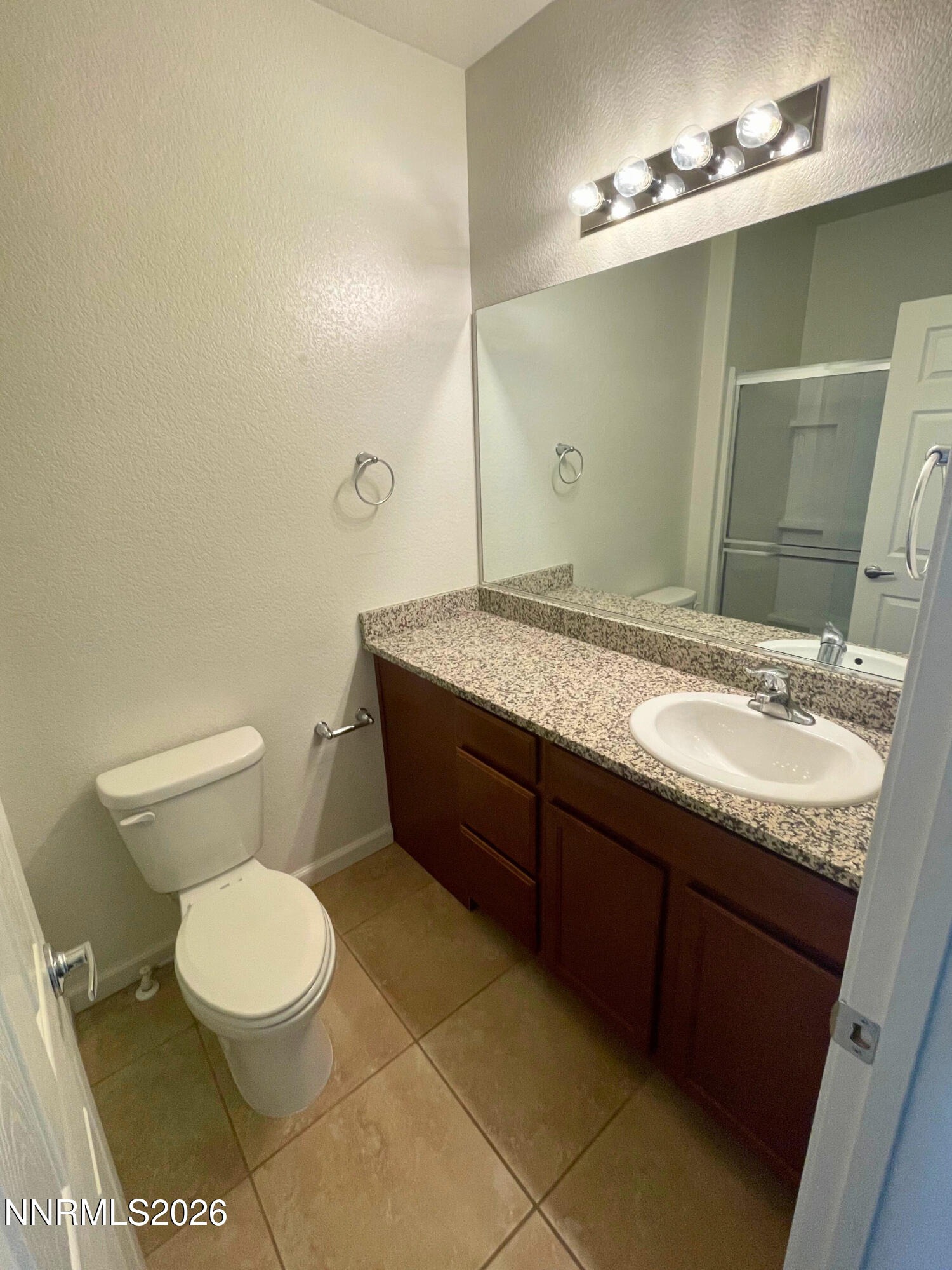 3050 Sterling Ridge Circle Sparks, NV 89431 - Photo 7 of 10 a bathroom with a granite countertop toilet sink and mirror