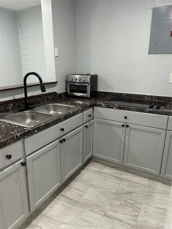 a kitchen with a sink and cabinets