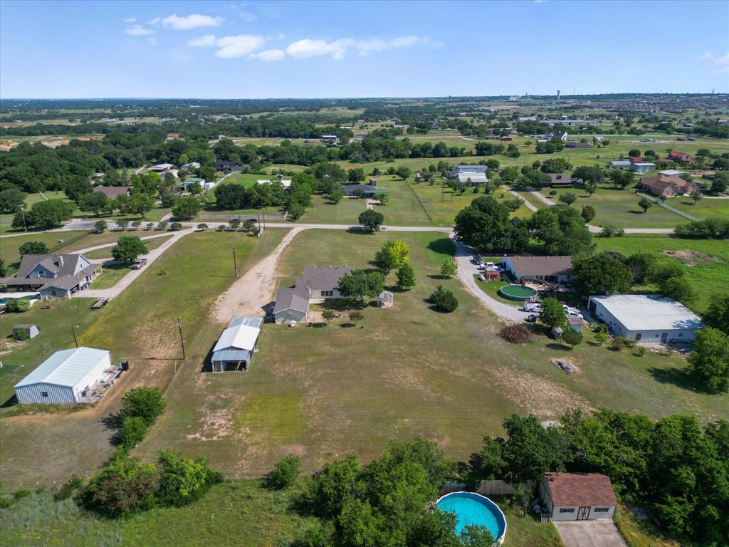 289 County Road 4655 Rhome, TX 76078 - Photo 31 of 34 Expansive property featuring multiple outbuildings, a detached garage, and an above-ground swimming pool