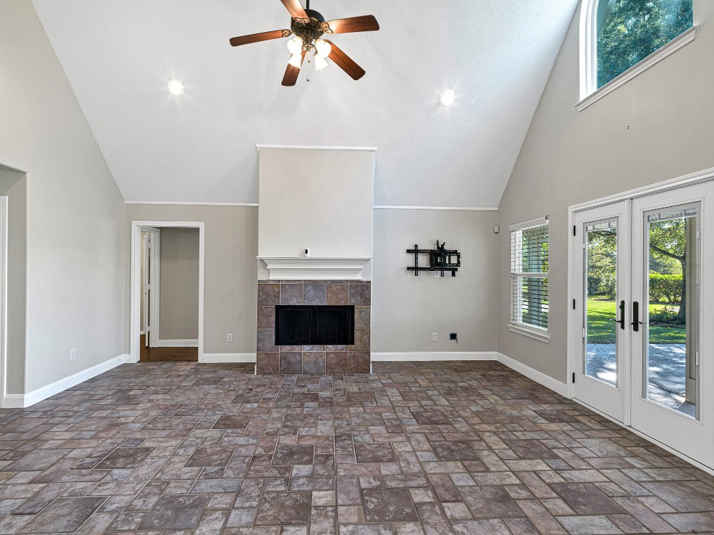 32601 Rogers Road Fulshear, TX 77441 - Photo 16 of 50 Imagine family gatherings in this living room or just cozy up to the fireplace with your morning coffee and take in the amazing view of the pool and lush greenery!