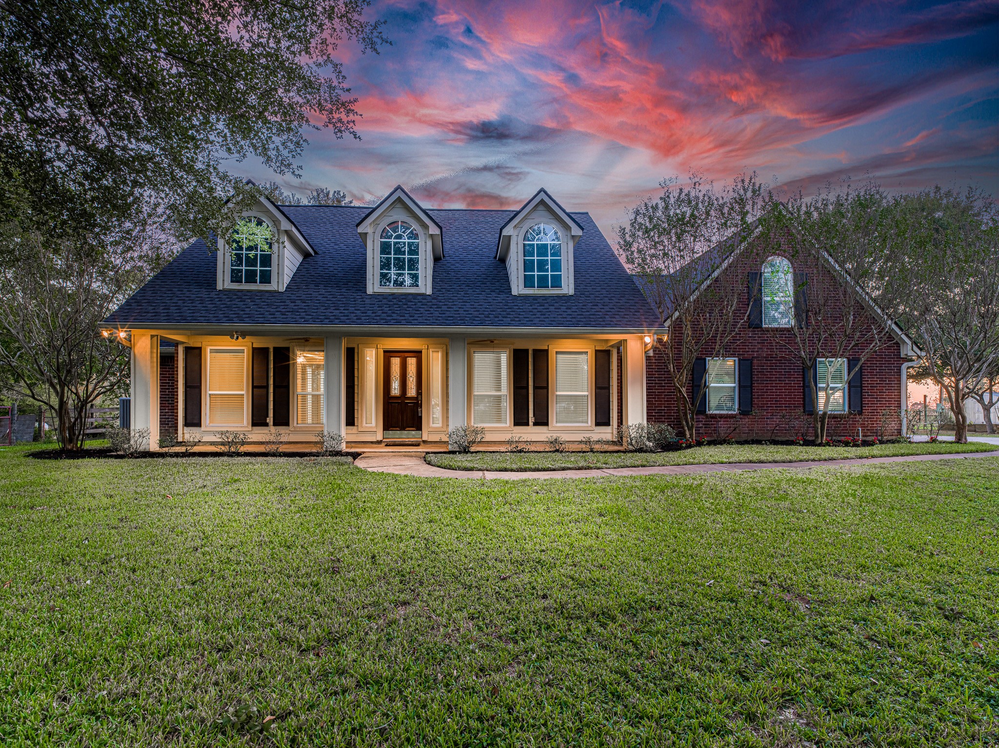 32601 Rogers Road Fulshear, TX 77441 - Photo 2 of 50 From the moment you arrive, you’ll be captivated by the inviting front porch, classic dormer windows, and beautifully manicured lawn framed by mature trees. Its warm brick accents and crisp white columns to the gleaming entryway sets the tone for the charm within.