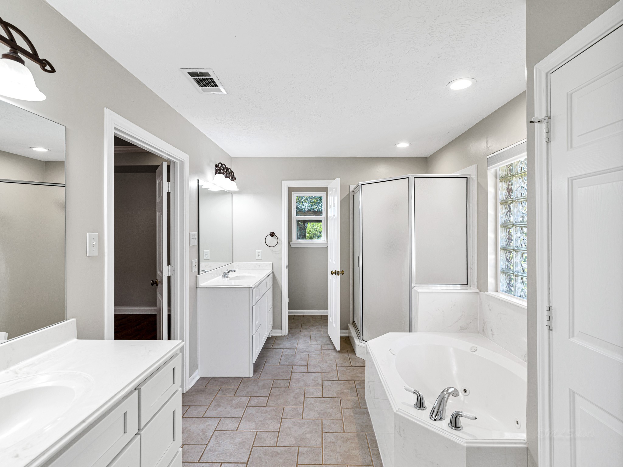32601 Rogers Road Fulshear, TX 77441 - Photo 29 of 50 Look at this stunning primary bathroom! It includes double sinks, a garden tub, and a separate shower.