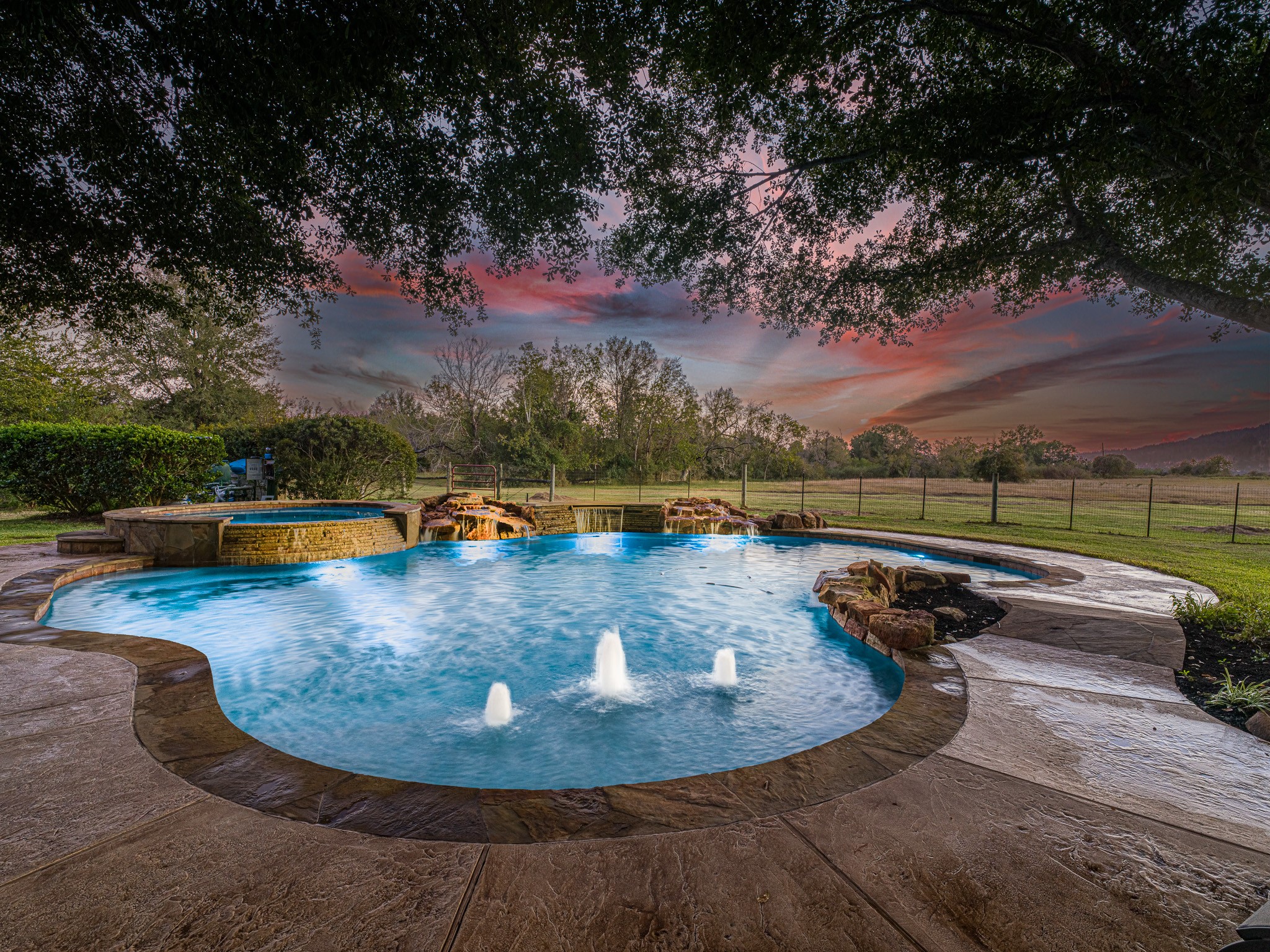 32601 Rogers Road Fulshear, TX 77441 - Photo 39 of 50 Enjoy the sunset while relaxing in this great heated pool with a hot tub and bubblers.