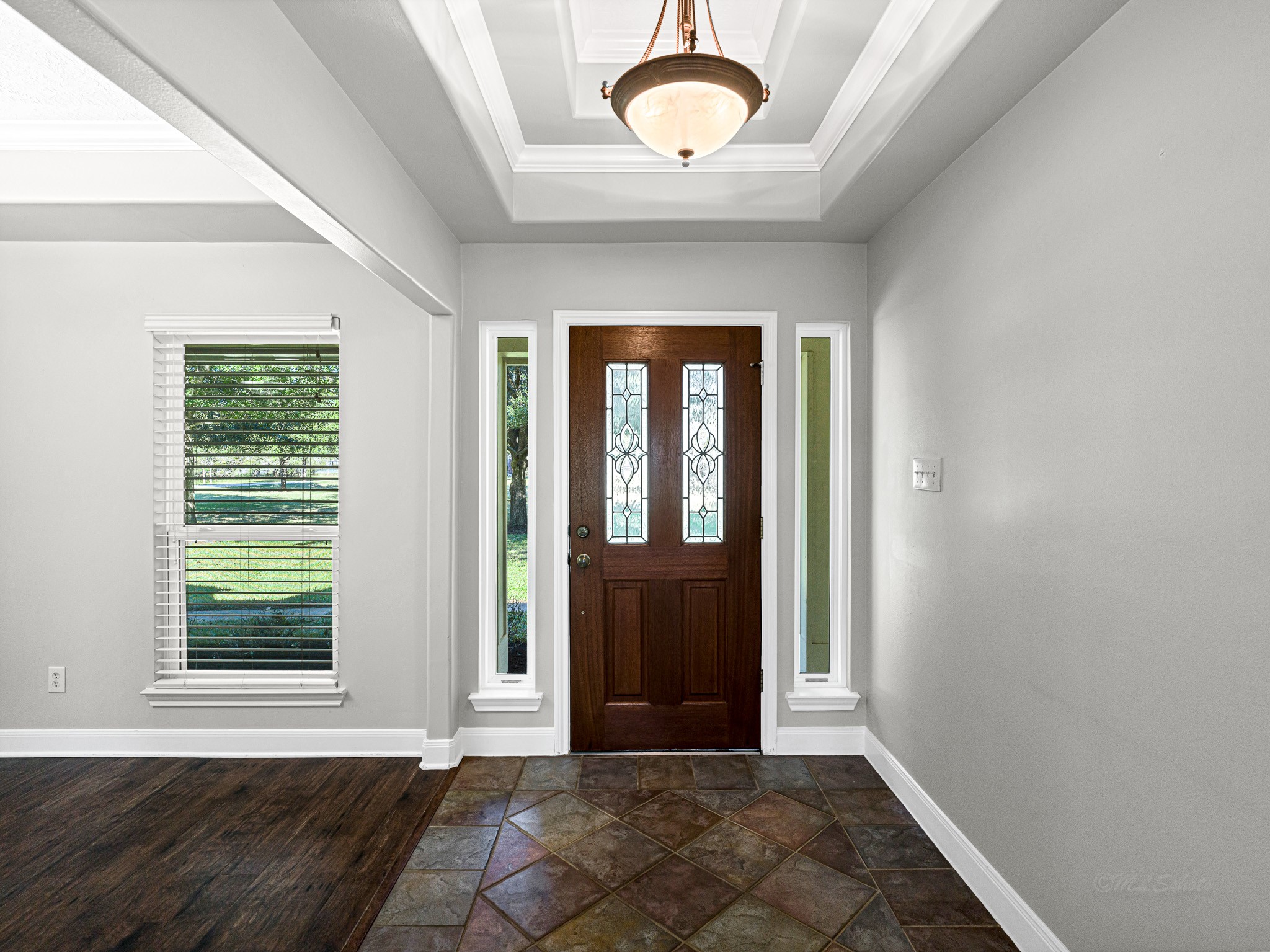 32601 Rogers Road Fulshear, TX 77441 - Photo 8 of 50 This inviting foyer with double tray ceiling just welcomes all your guest to your warm home.