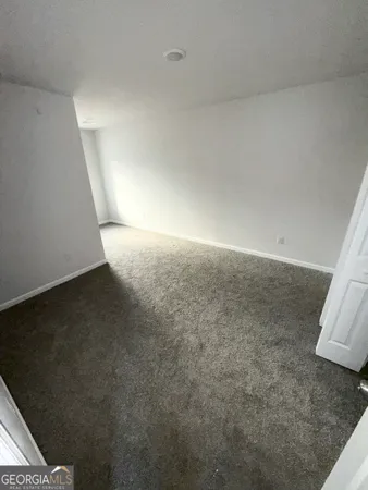 a view of a big room with closet and windows