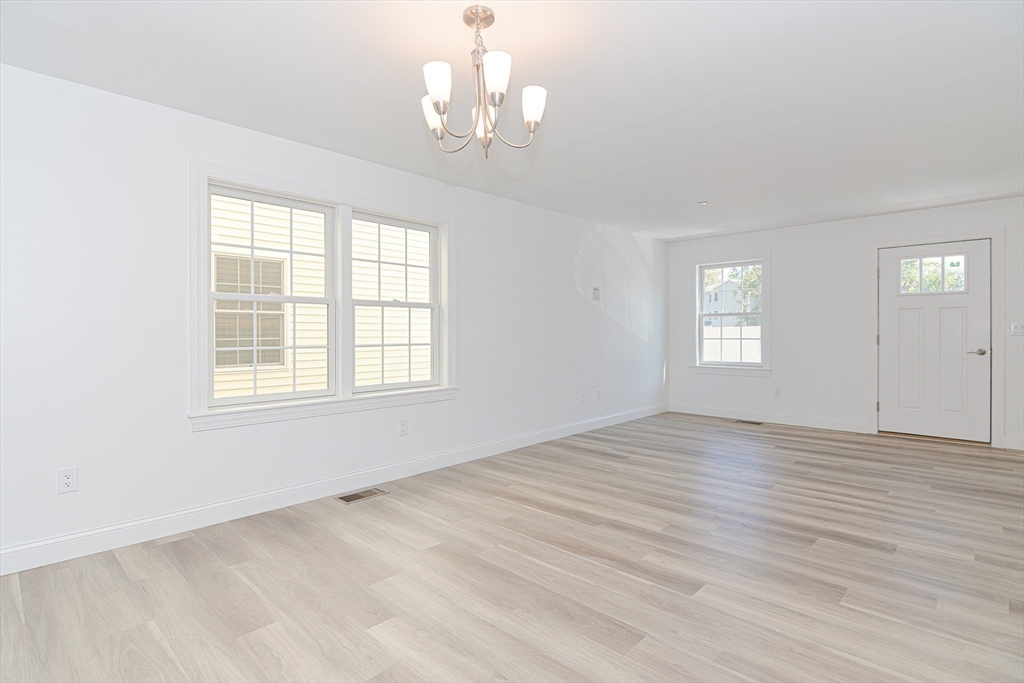 215 High Street, Unit 21 Taunton, MA 02780 - Photo 2 of 17 a view of empty room with wooden floor and fan