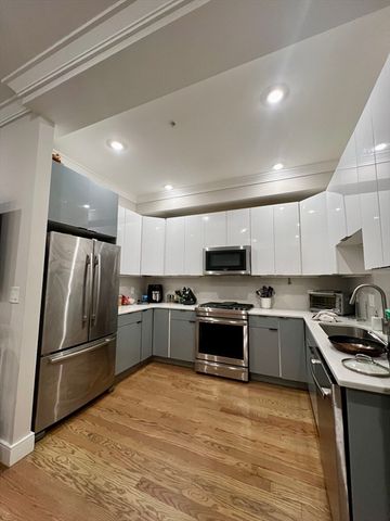 a kitchen with stainless steel appliances granite countertop a refrigerator stove top oven and sink