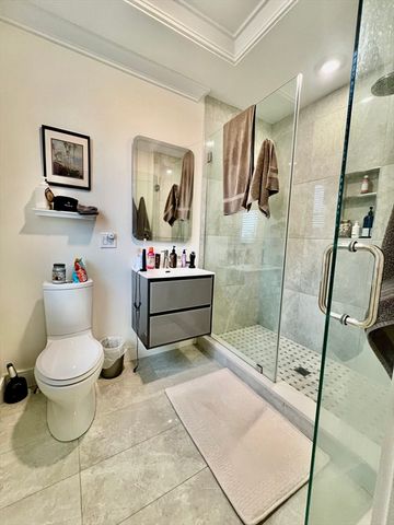 a kitchen with stainless steel appliances a stove top oven a sink a refrigerator and white cabinets