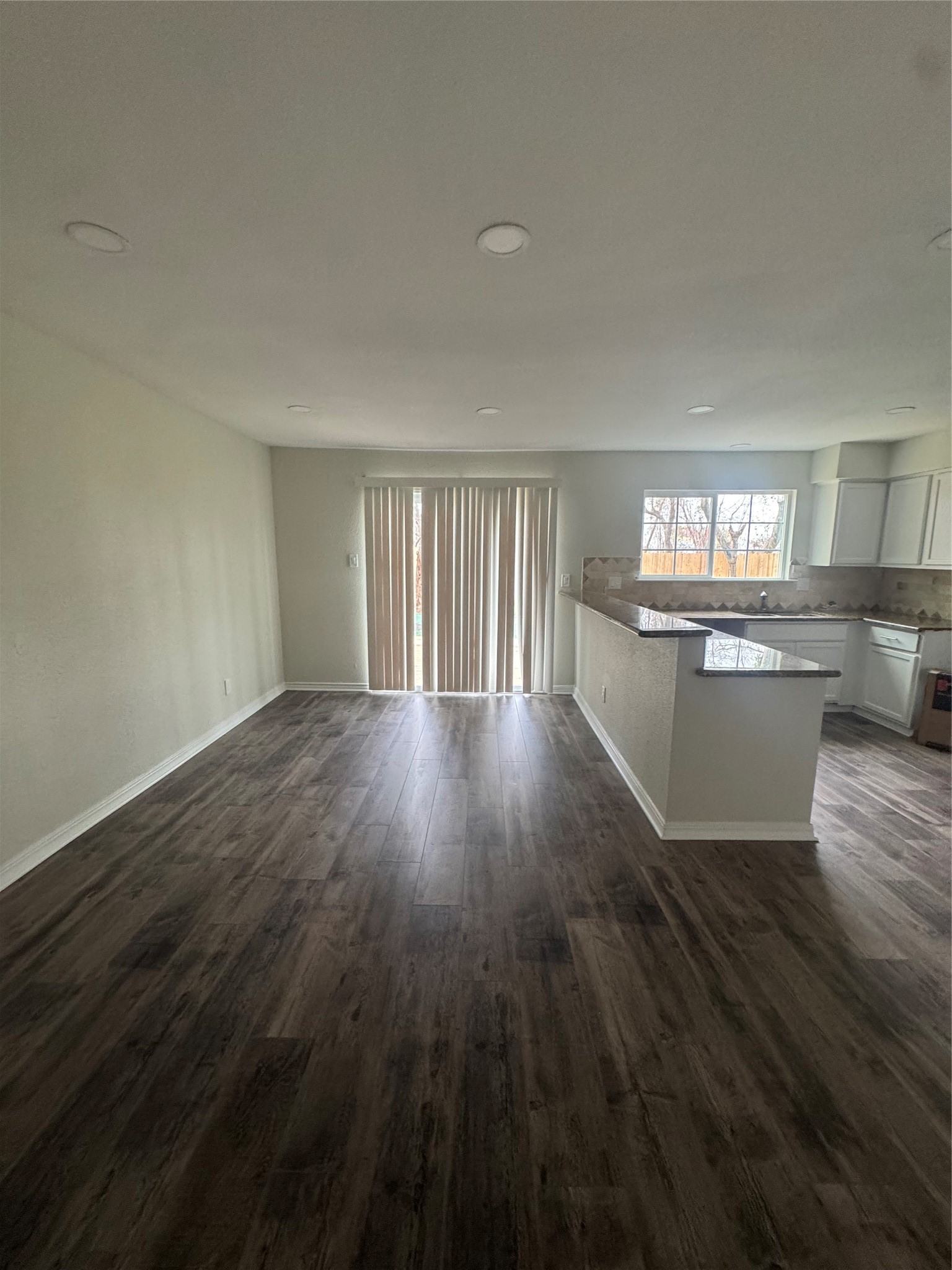 13626 Sunswept Way Houston, TX 77082 - Photo 9 of 30 a view of a kitchen with wooden floor and a window