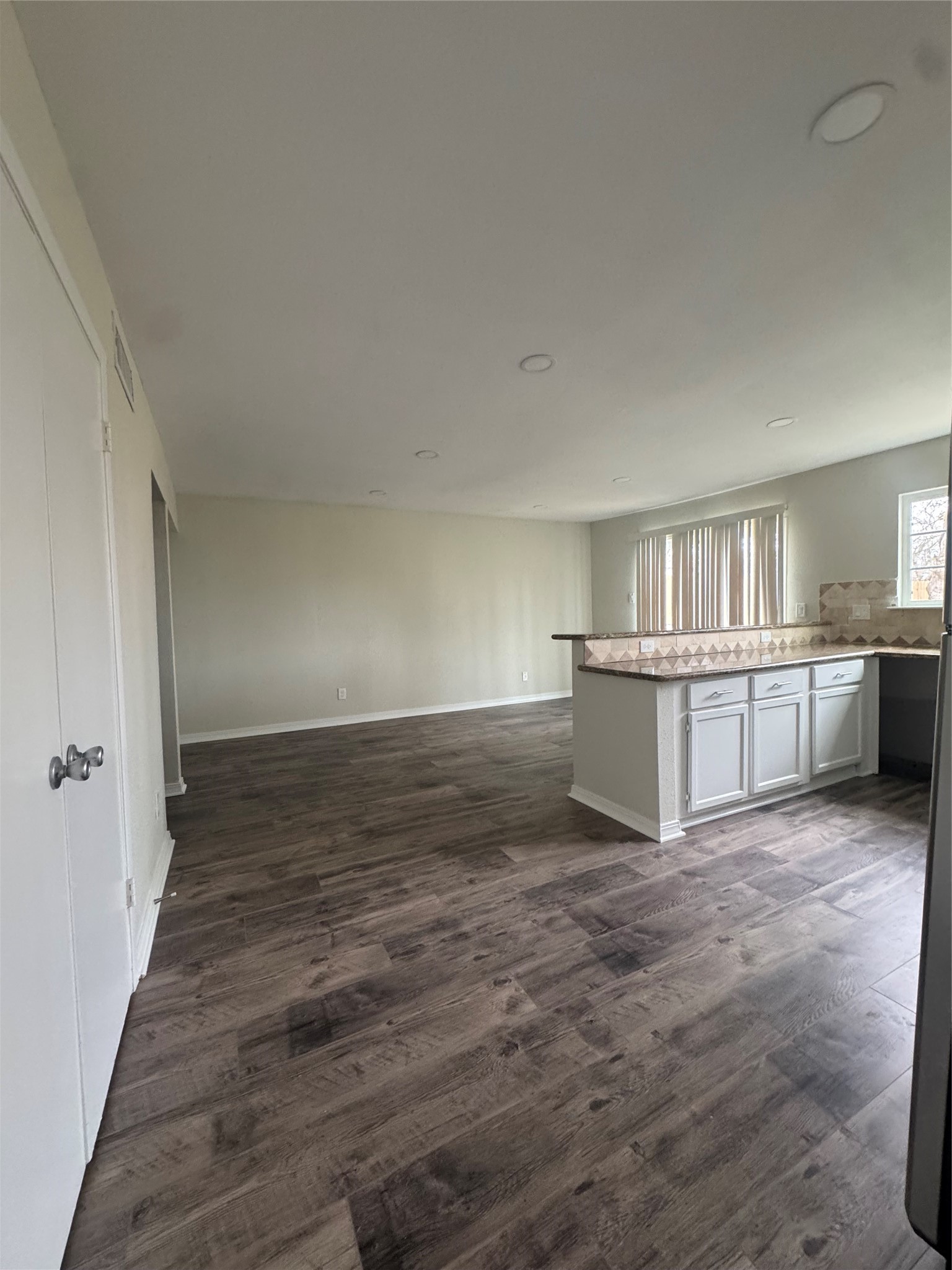 13626 Sunswept Way Houston, TX 77082 - Photo 10 of 30 a view of kitchen and empty room with wooden floor