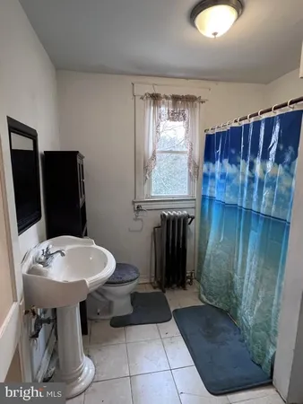 a bathroom with a sink toilet and mirror