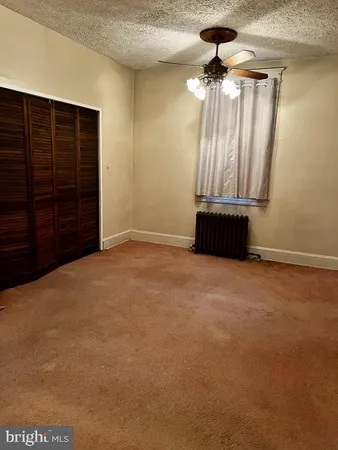 a view of an empty room with a cabinet