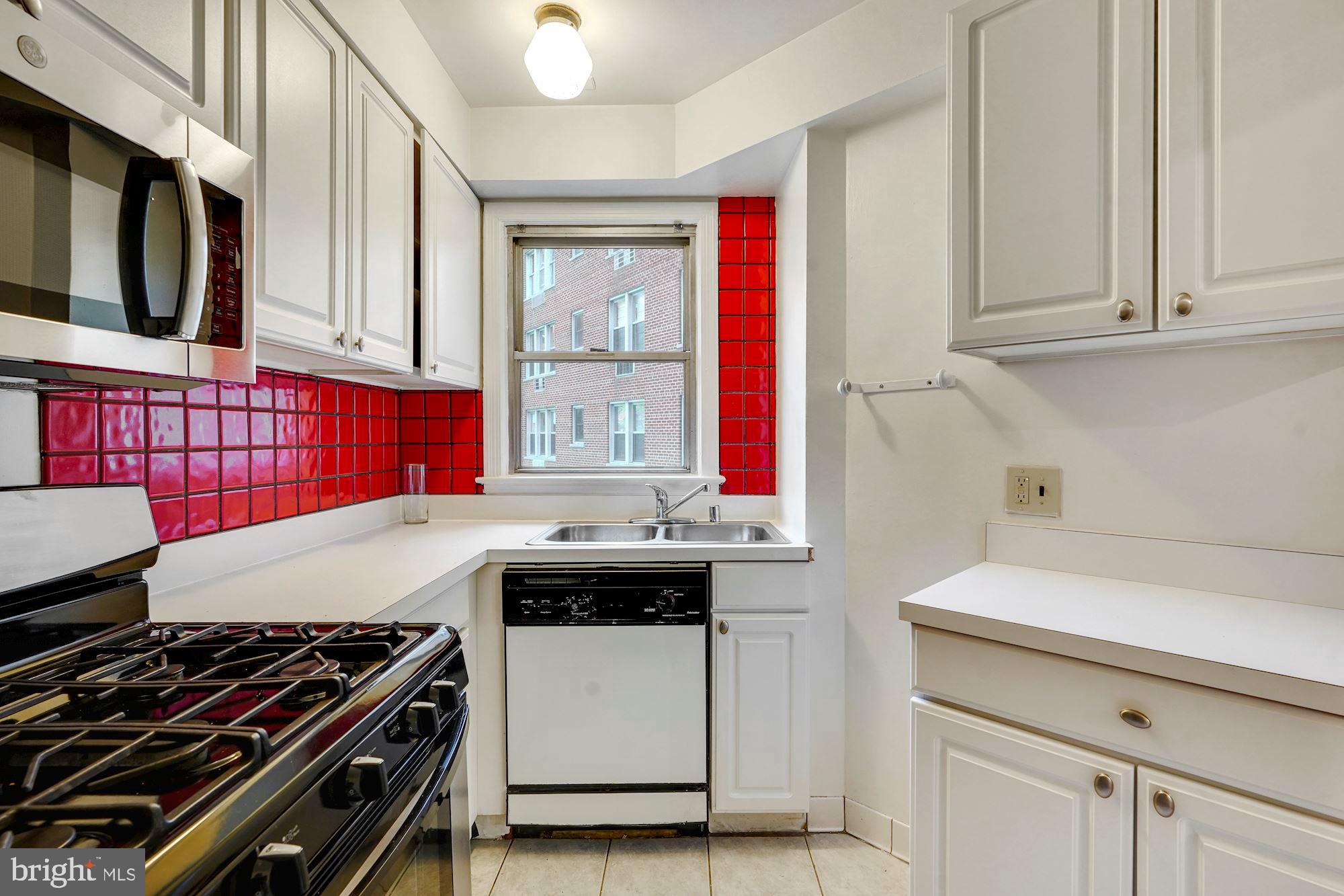 2500 Q Street Northwest, Unit 216 Washington, DC 20007 - Photo 11 of 38 a kitchen that has a sink and a stove