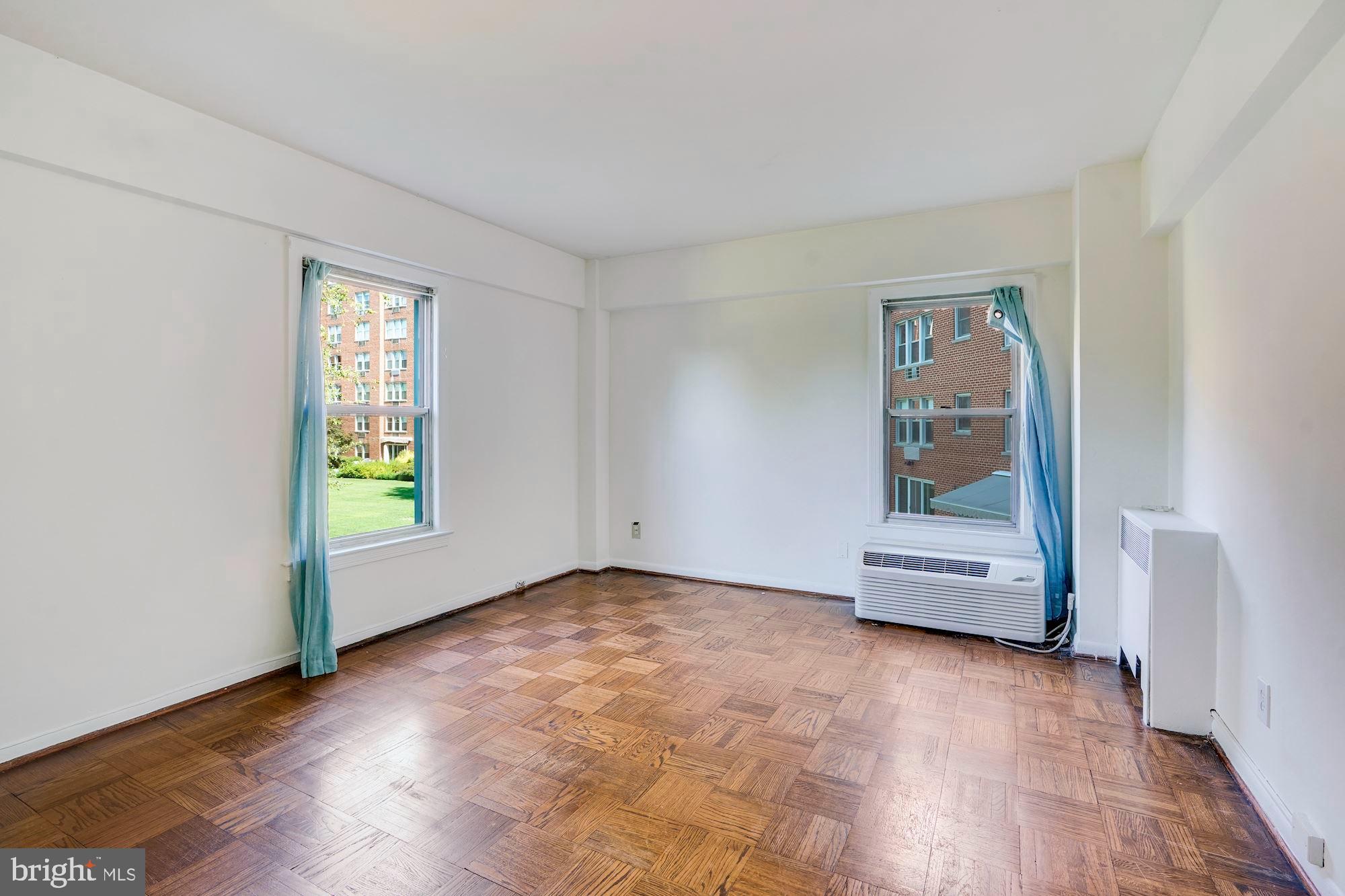 2500 Q Street Northwest, Unit 216 Washington, DC 20007 - Photo 15 of 38 wooden floor in an empty room with a window