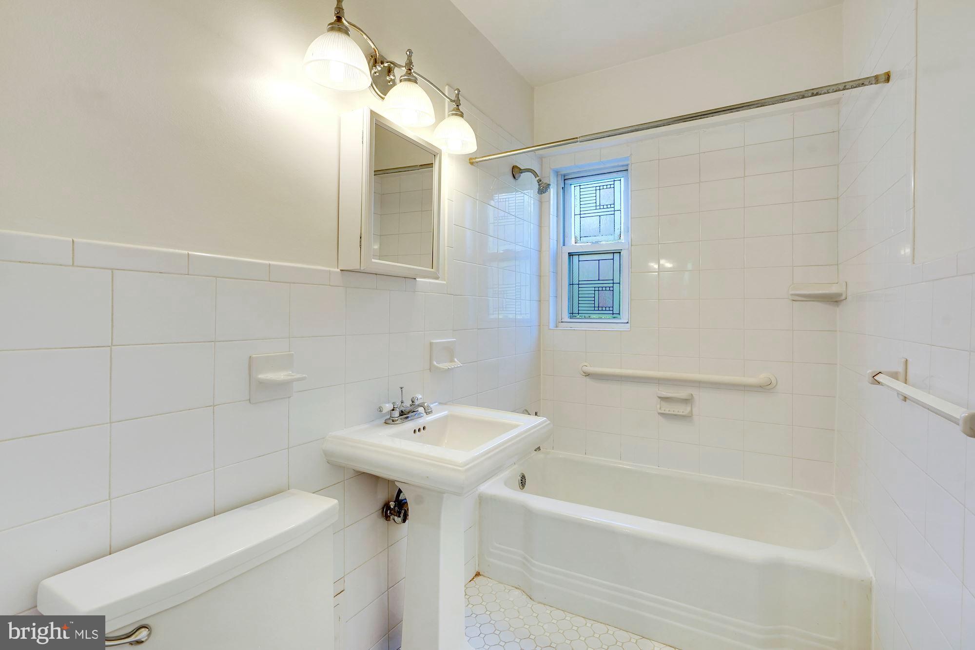 2500 Q Street Northwest, Unit 216 Washington, DC 20007 - Photo 20 of 38 a bathroom with a sink a toilet and shower