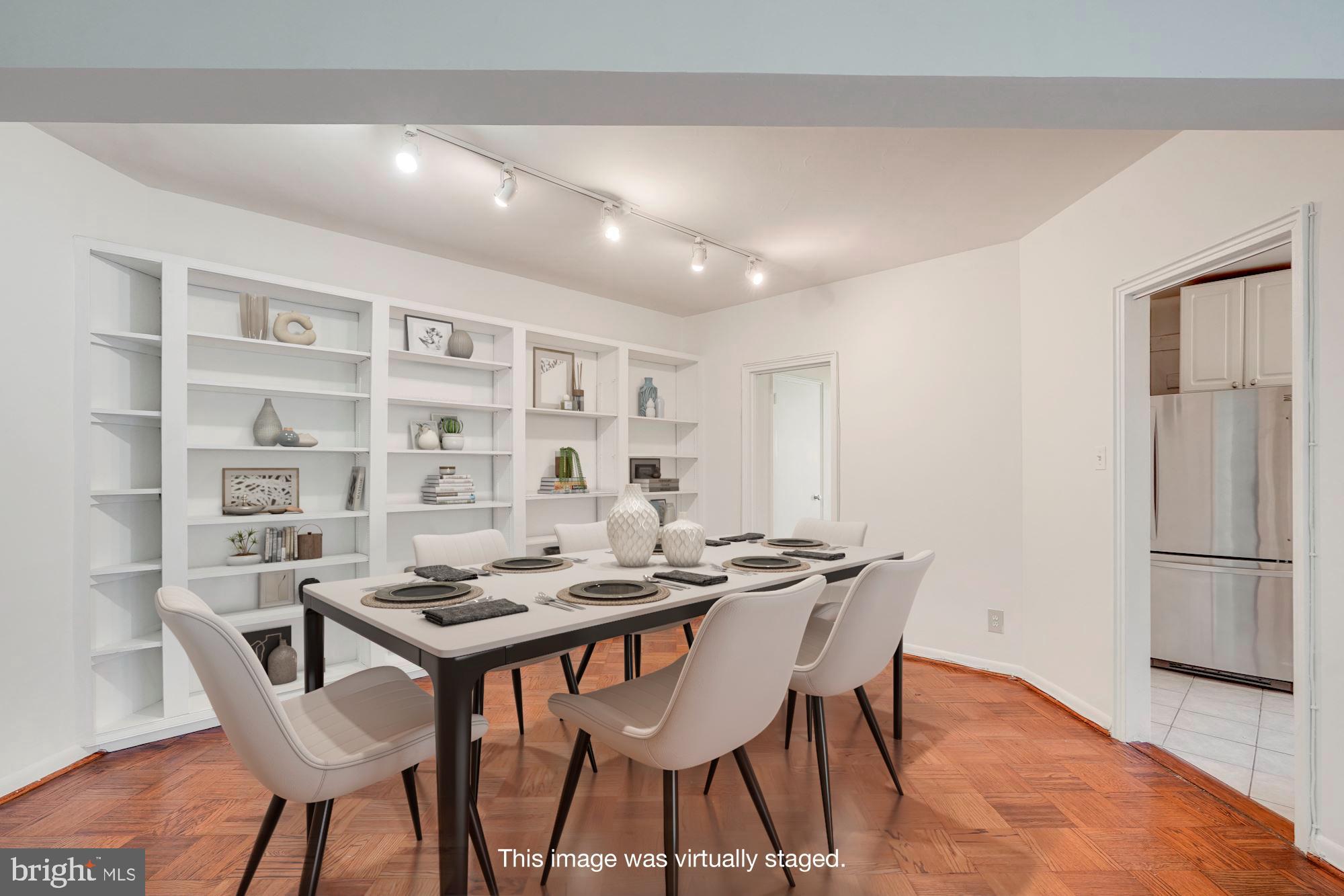 2500 Q Street Northwest, Unit 216 Washington, DC 20007 - Photo 4 of 38 a view of a dining room with furniture and wooden floor