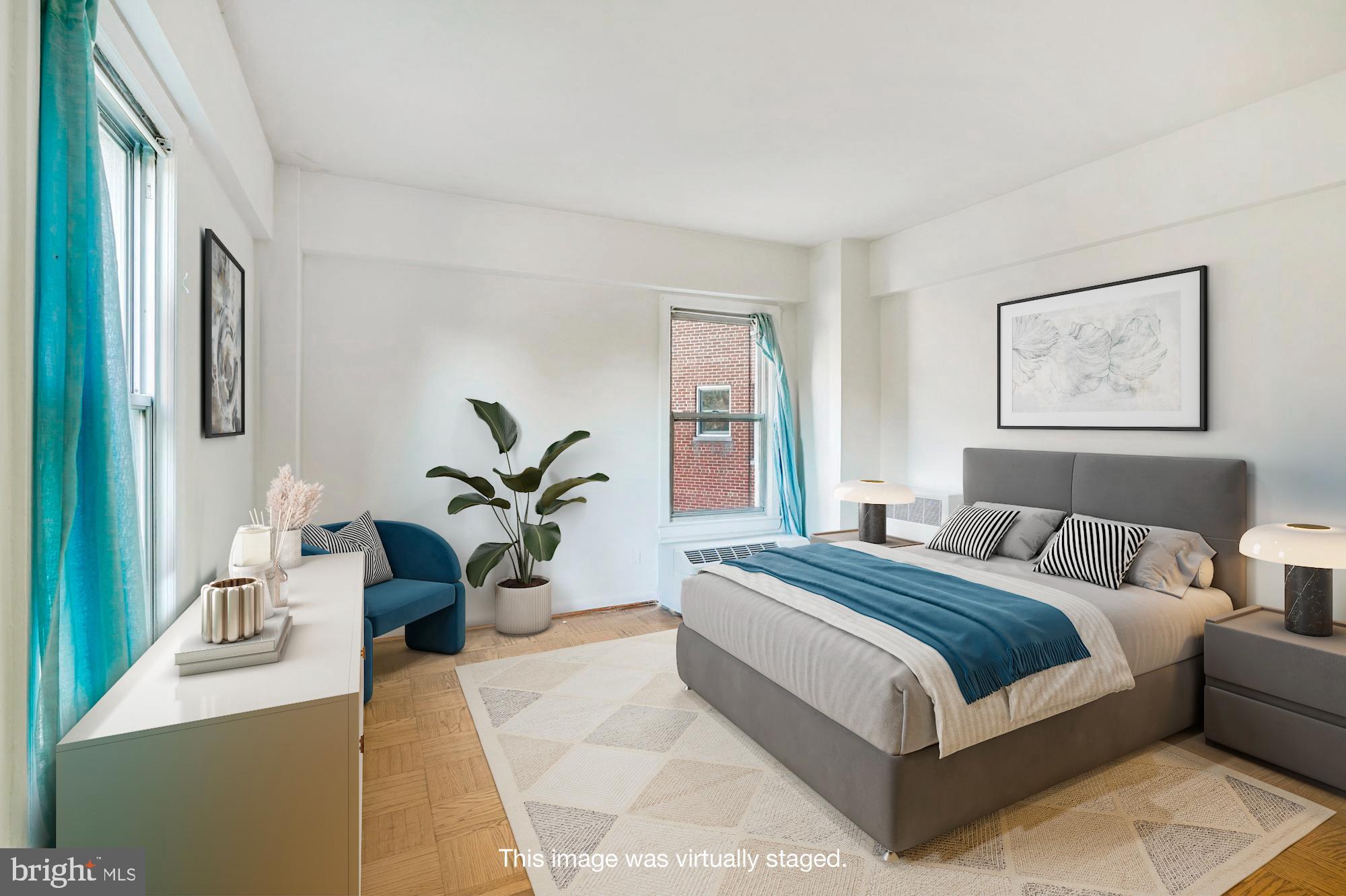 2500 Q Street Northwest, Unit 216 Washington, DC 20007 - Photo 5 of 38 a bedroom with a large bed and potted plant