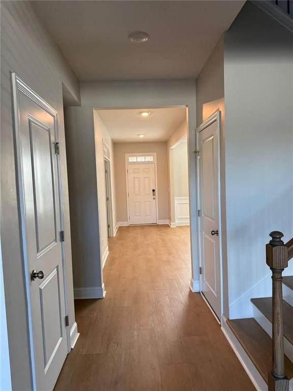 7410 Ansley View Lane Cumming, GA 30028 - Photo 11 of 35 a view of hallway with livingroom and wooden floor