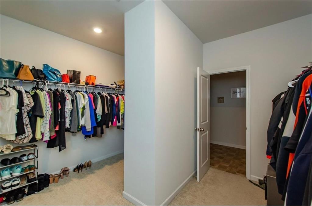 7410 Ansley View Lane Cumming, GA 30028 - Photo 14 of 35 a view of walk in closet with clothes