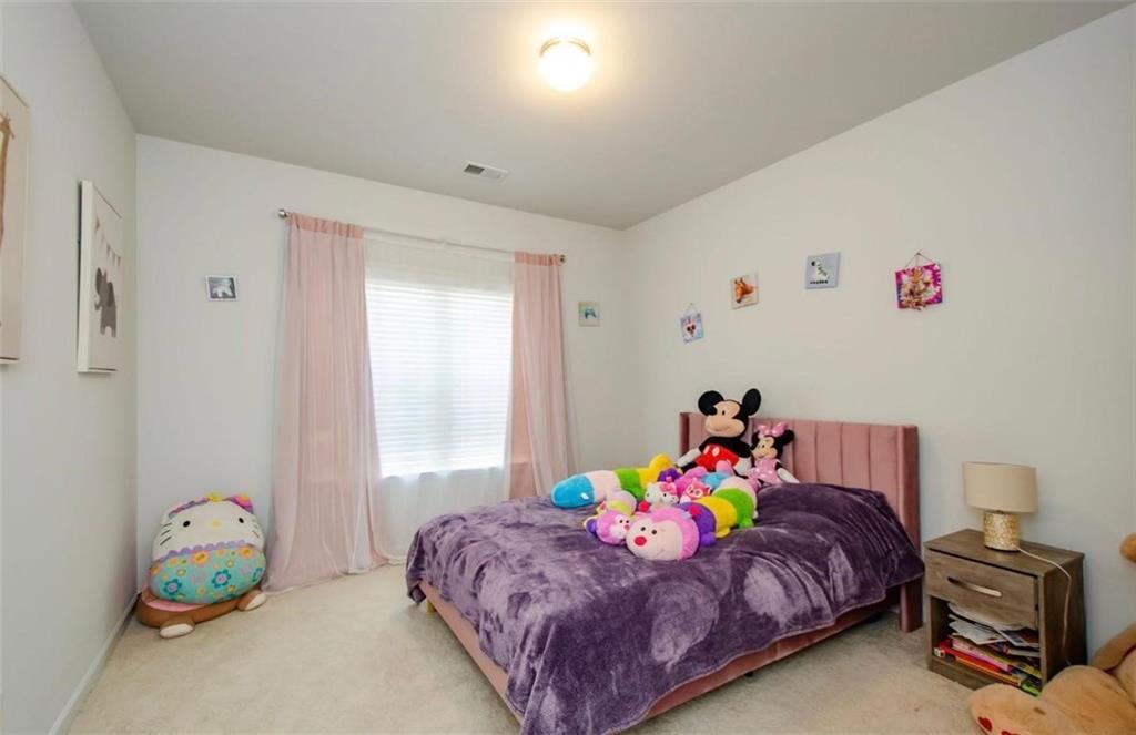 7410 Ansley View Lane Cumming, GA 30028 - Photo 25 of 35 a bedroom with a bed and a window