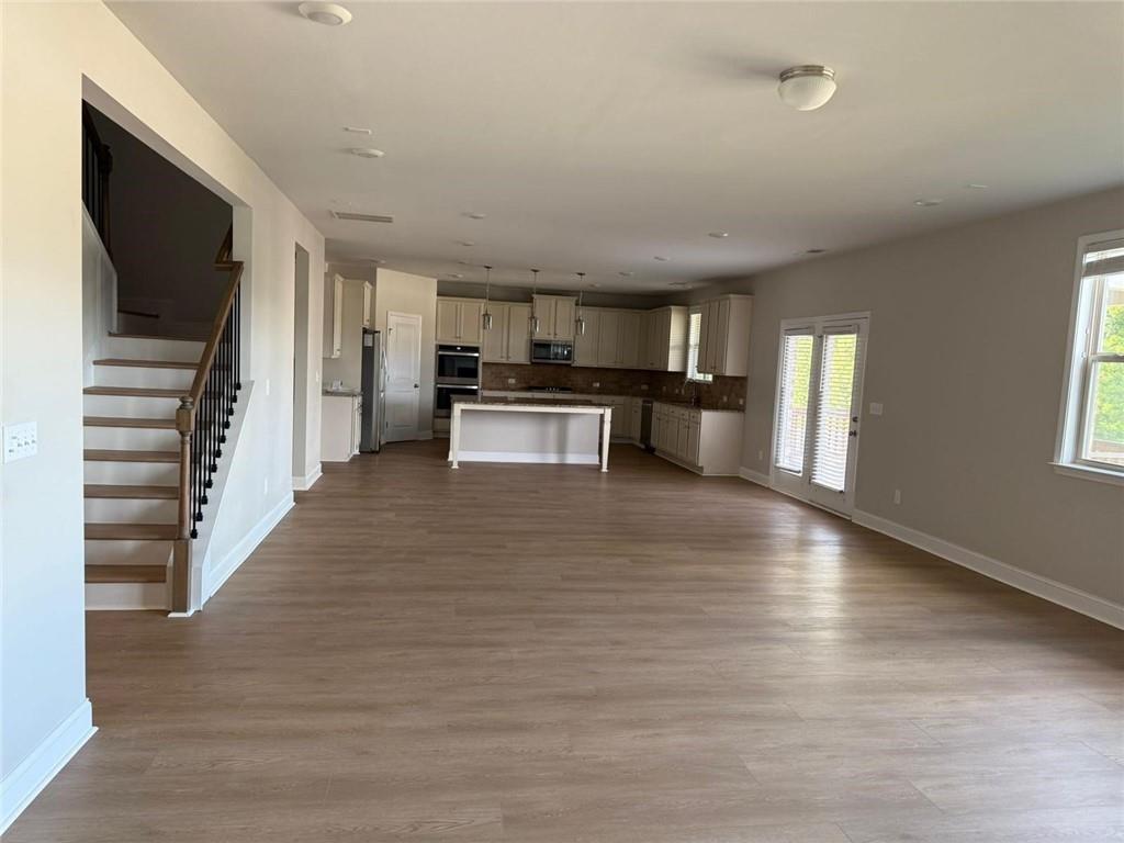7410 Ansley View Lane Cumming, GA 30028 - Photo 5 of 35 a kitchen with a refrigerator and a stove top oven
