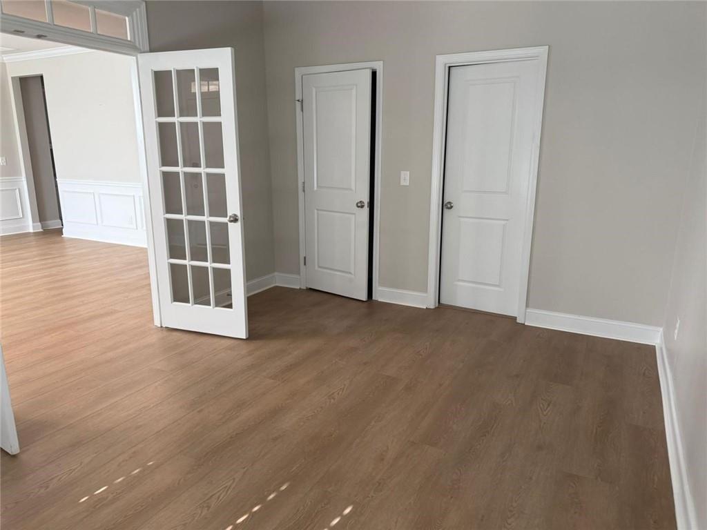 7410 Ansley View Lane Cumming, GA 30028 - Photo 10 of 35 an empty room with wooden floor and windows
