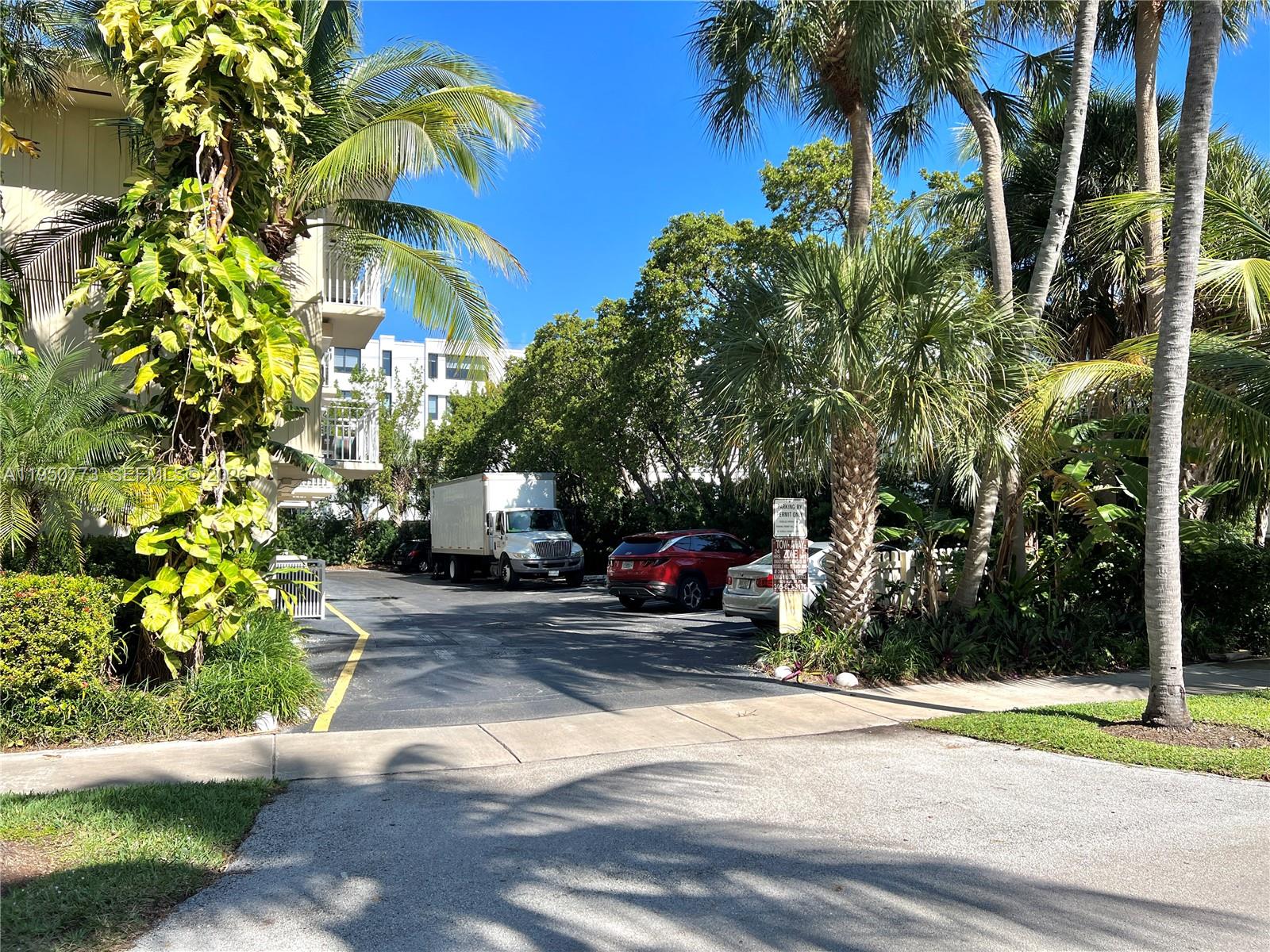 255 Sunrise Drive, Unit 308 Key Biscayne, FL 33149 - Photo 14 of 18 a view of a house with a yard and sitting area