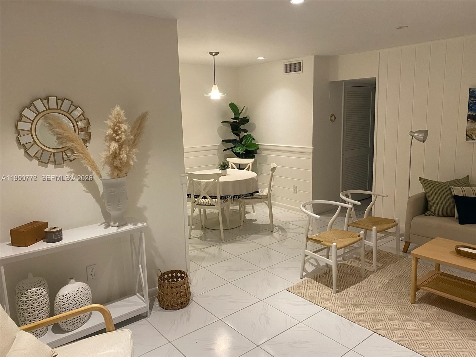 255 Sunrise Drive, Unit 308 Key Biscayne, FL 33149 - Photo 3 of 18 a living room with furniture and a chandelier