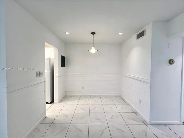 a view of an empty room and a window