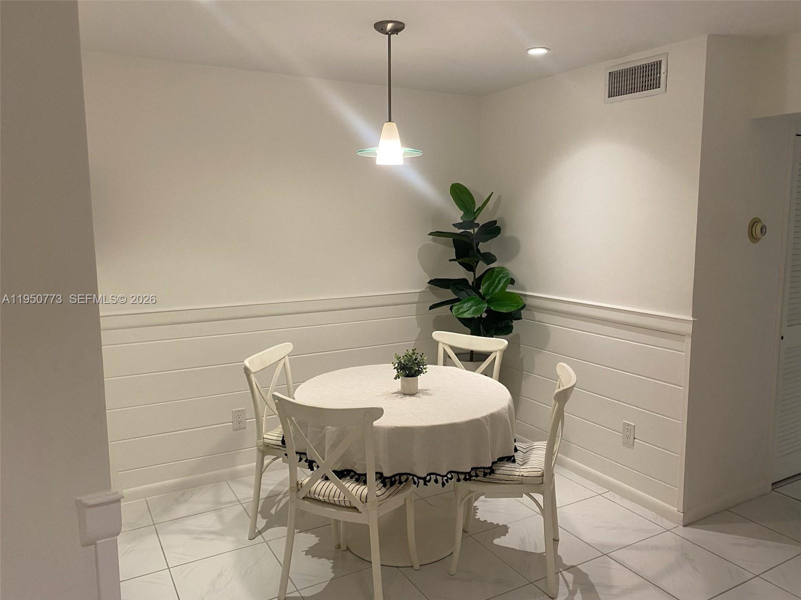 255 Sunrise Drive, Unit 308 Key Biscayne, FL 33149 - Photo 6 of 18 a dining room with furniture and a potted plant