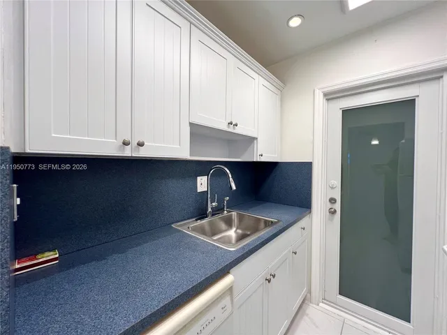 a kitchen with a sink and cabinets