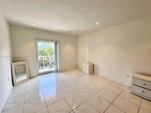 a view of an empty room and a window