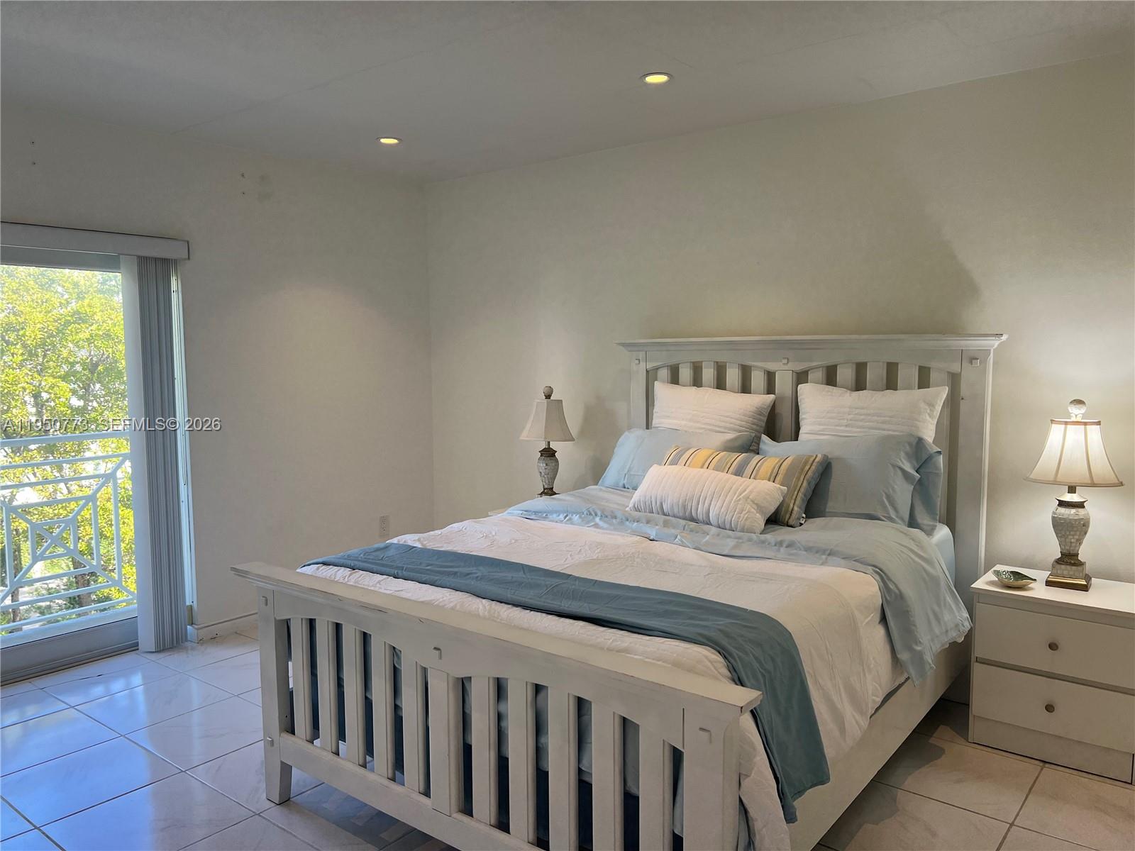 255 Sunrise Drive, Unit 308 Key Biscayne, FL 33149 - Photo 10 of 18 a bedroom with a bed and a window