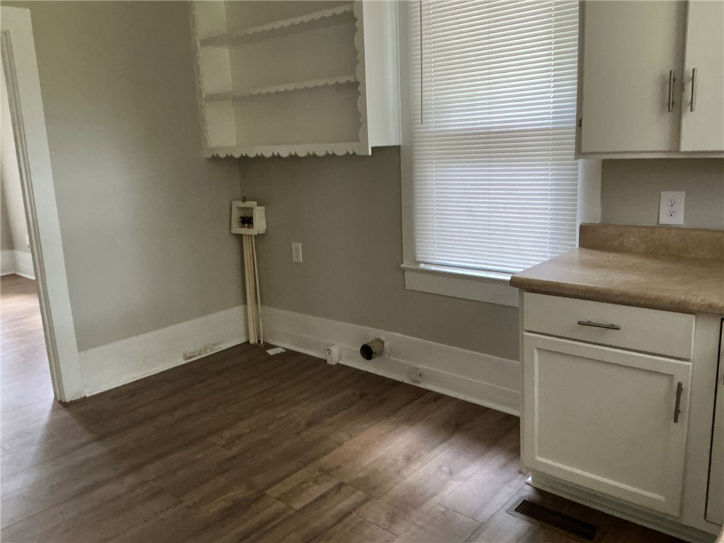 504 Caughlin Avenue Anderson, SC 29624 - Photo 7 of 15 Functional kitchen prep area with laminate counters and warm wood flooring.