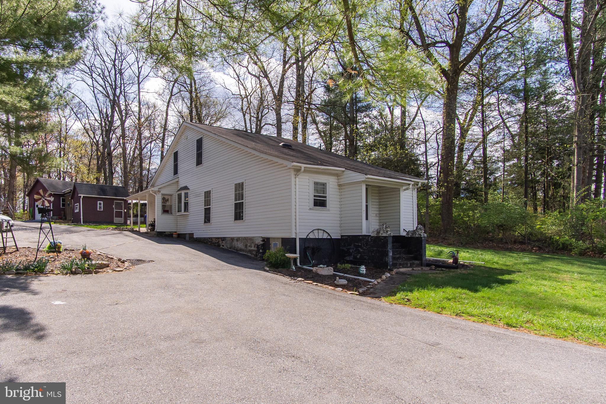 a view of a house with a yard covered with snow in the background