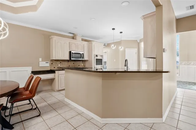 a kitchen with stainless steel appliances granite countertop a refrigerator sink and cabinets