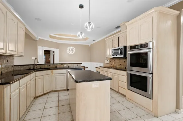 a large kitchen with cabinets and stainless steel appliances