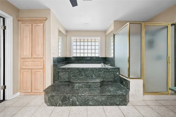 a bathroom with a bathtub and shower