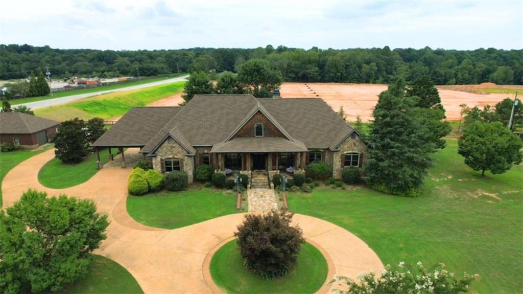 a view of a house with swimming pool and a yard