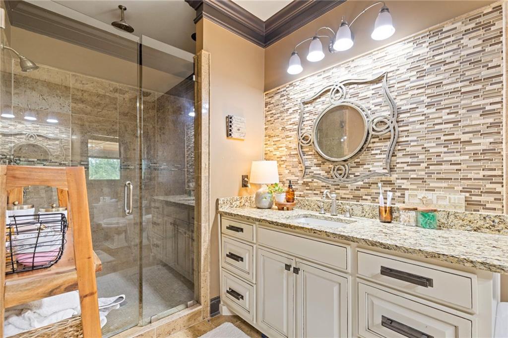 2932 Highway 124 Jefferson, GA 30549 - Photo 20 of 46 a bathroom with a sink vanity mirror and shower