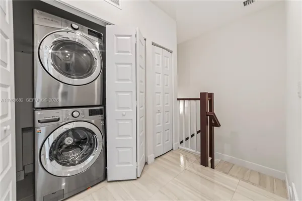 a view of a hallway with washer and dryer