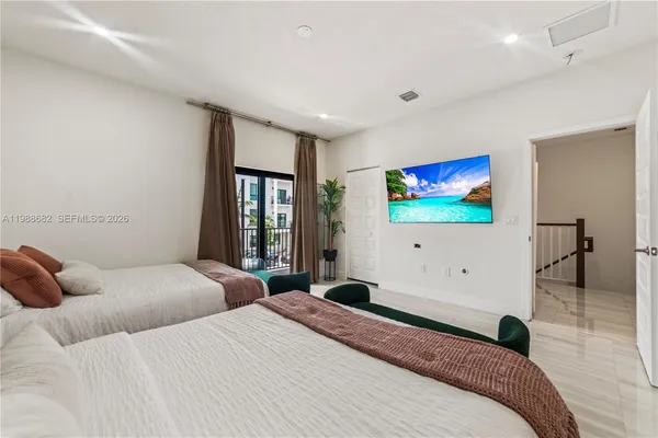 a bedroom with a bed and a flat screen tv