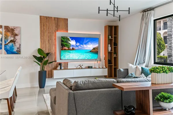 a living room with furniture and a potted plant