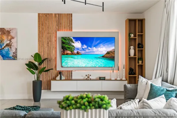 a living room with furniture and a potted plant